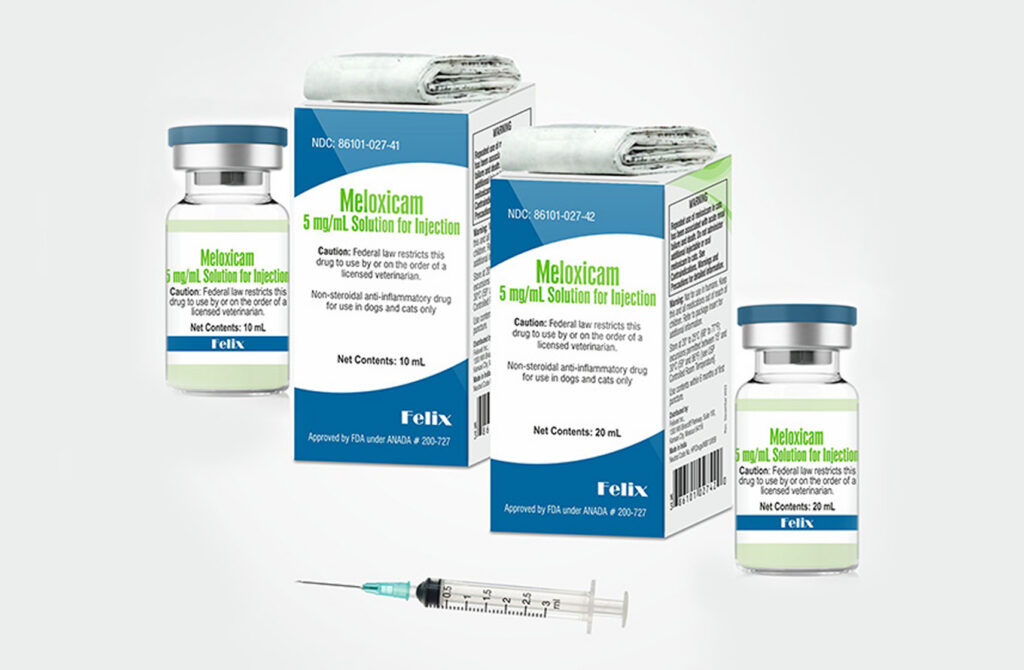 Two boxes and two vials for Meloxicam Solution for Injection for dogs and cats in 10 mL and 20 mL sizes, with a syringe in the foreground.